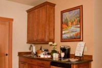 Guest service center with refrigerator, ice, mugs, wine glasses, coffee, tea, housebaked cookies